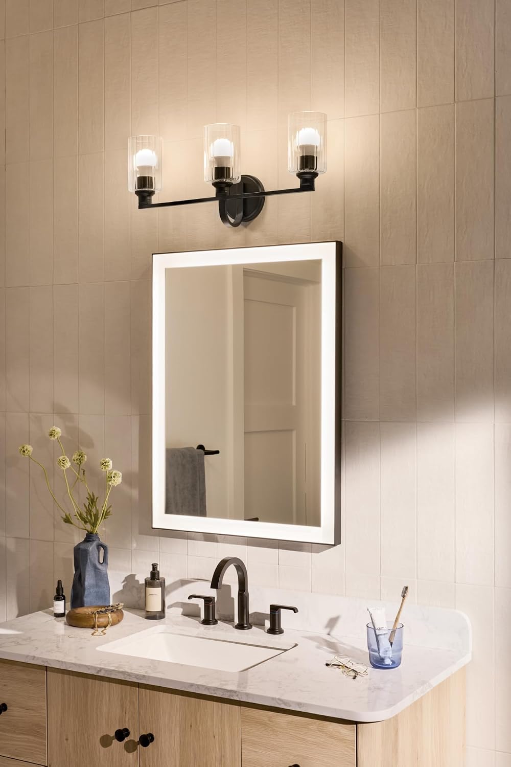Kichler Gioe 24.25' 3-Light Bathroom Vanity Light Fixture with Clear Fluted Glass in Black, Modern Wall Mount Over Mirror for Powder Room, Damp Rated (24.25' W x 10.5' H), 55226BKFLU